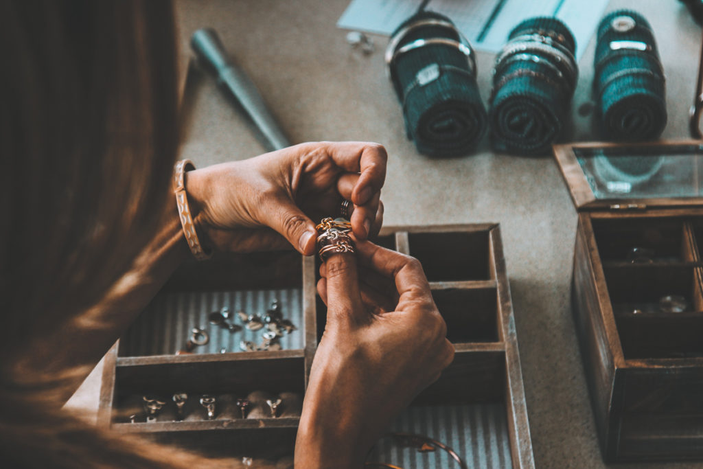 A professional jeweller sizing rings for valuation.
