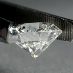 A cut diamond carefully being held ready for grading, Wellington Jewellery Valuations.